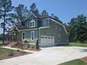 Side view of an attractive home showing the garage, neat landscaping, and clean architectural lines at 15 Independence Dr, Smithfield, NC 27577