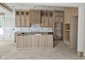 Unfinished kitchen boasting custom wooden cabinets and a center island with vertical wood slat detailing at 15 Independence Dr, Smithfield, NC 27577