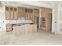 Unfinished kitchen boasting custom wooden cabinets and a center island with vertical wood slat detailing at 15 Independence Dr, Smithfield, NC 27577