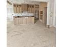 Unfinished kitchen boasting custom wooden cabinets and a center island with vertical wood slat detailing at 15 Independence Dr, Smithfield, NC 27577