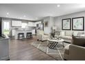 Open-concept living room with modern decor, seamlessly connected to a kitchen with stainless steel appliances and a kitchen island at 1595 Ivy Meadow Ln, Zebulon, NC 27597