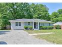 Well-maintained single-story home with updated siding and a gravel driveway complementing the green lawn at 1708 S Alston Ave, Durham, NC 27707
