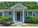 Inviting front entrance with a decorative door and brick accents, framed by manicured shrubs at 1708 S Alston Ave, Durham, NC 27707
