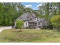 Beautiful home with a mix of stone and siding, complemented by a well-manicured front lawn at 1710 Eddy Ct, Franklinton, NC 27525