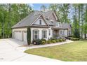 Charming house with a three car garage, beautifully landscaped yard, and welcoming front porch at 1710 Eddy Ct, Franklinton, NC 27525