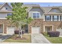 Charming townhouse with stone accents, well-maintained landscaping, and attached one car garage at 19 Sangre De Cristo Dr, Durham, NC 27705