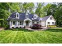 Beautifully maintained home with a lush lawn and classic architectural details at 202 Homestead Dr, Cary, NC 27513