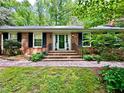 Home featuring a classic brick facade, black shutters, and beautiful brick entrance at 204 N Elliott Rd, Chapel Hill, NC 27514