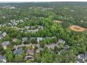 Aerial view of a neighborhood surrounded by lush greenery, baseball and green fields at 206 Wagon Trail Dr, Cary, NC 27513
