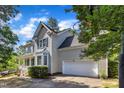 Two story home with a two car garage and basketball hoop in the driveway at 206 Wagon Trail Dr, Cary, NC 27513