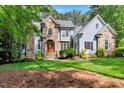 Stunning two-story home with stone and siding exterior and lush green lawn at 2201 Avinshire Pl, Wake Forest, NC 27587