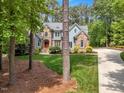 Beautiful home with a well-maintained lawn, stone accents, and a long driveway at 2201 Avinshire Pl, Wake Forest, NC 27587