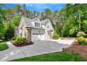 Charming home featuring a stone-accented facade, garage, and well-manicured landscaping at 2201 Avinshire Pl, Wake Forest, NC 27587