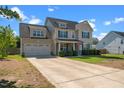 Beautiful two-story home featuring a lush lawn and an inviting covered porch at 244 N Prince Henry Way, Cameron, NC 28326