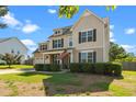 Beautiful two-story home featuring a lush lawn and an inviting covered porch at 244 N Prince Henry Way, Cameron, NC 28326