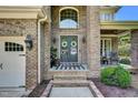 Inviting front porch with double doors, brick entryway, rocking chair, and cozy decor at 2637 Forestbluff Dr, Fuquay Varina, NC 27526