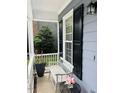 Charming porch with a white bench, black shutters, and a small decorative table at 2908 Bolo Trl, Raleigh, NC 27615