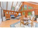 Sun-filled living room boasts wood-paneled walls, a cathedral ceiling and an elegant chandelier at 300 Rabbit Run, Pittsboro, NC 27312