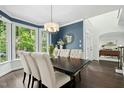Elegant dining room with hardwood floors, bay window, and stylish chandelier at 308 Hassellwood Dr, Cary, NC 27518