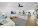 Spacious living room with hardwood floors, white sofas, and open layout to the kitchen at 310 Georgetown Rd, Raleigh, NC 27608