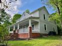 Exterior view of home with large front porch, showcasing landscaping and architectural details at 330 W King St, Hillsborough, NC 27278