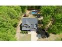 An aerial view of a house with a swimming pool, surrounded by lush greenery and a well-maintained lawn at 335 Gwendolyn Way, Fuquay Varina, NC 27526