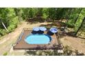 Aerial shot showcasing a refreshing in-ground pool, deck, and seating, nestled in a private backyard oasis at 335 Gwendolyn Way, Fuquay Varina, NC 27526