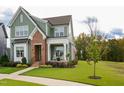 Beautiful two-story home featuring a welcoming front porch, lush green lawn, and attractive landscaping at 337 Sunset Hill Ln, Wendell, NC 27591