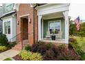 Inviting front porch with rocking chairs, brick entryway, and well-maintained landscaping, creates a welcoming curb appeal at 337 Sunset Hill Ln, Wendell, NC 27591