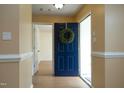 Inviting foyer with wood floors and a bright blue front door adorned with a green wreath at 3521 Piedmont Dr, Raleigh, NC 27604