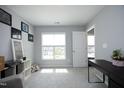 Bright bedroom with neutral walls, carpeted floor, and a window for natural light at 39 Principal Way, Clayton, NC 27520