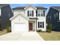 Charming two-story home featuring a driveway, garage, and a welcoming front entrance at 39 Principal Way, Clayton, NC 27520