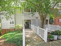Charming condo exterior with a welcoming walkway, covered porch, and lush landscaping for curb appeal at 403 Gooseneck Dr # A-1, Cary, NC 27513