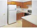 The kitchen features bright countertops, wood cabinets, and appliances including an oven and refrigerator at 403 Gooseneck Dr # A-1, Cary, NC 27513