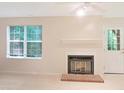Living room features a fireplace, a window letting in natural light, and a door leading outside at 403 Gooseneck Dr # A-1, Cary, NC 27513