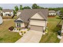 Residential neighborhood with a two-car garage, neat landscaping, and a paved driveway at 404 Lily Pad Ct, Zebulon, NC 27597