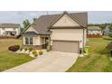 Attractive home with a two-car garage, neat landscaping, and a paved driveway at 404 Lily Pad Ct, Zebulon, NC 27597