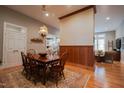 Elegant dining area with wood floors and trim, seamlessly connects to the living room and kitchen at 4331 Millcreek Cir, Pittsboro, NC 27312