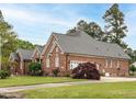 Brick home featuring a large driveway and well-manicured lawn and landscaping at 4501 Forest Dr, Holly Springs, NC 27540