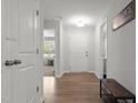 Bright foyer with light walls, wood-look floors, and a stylish wooden bench, creating a welcoming entry at 479 Kotata Ave, Bunnlevel, NC 28323