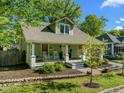 Charming home with inviting front porch, rocking chairs, and lush landscaping; a perfect blend of comfort and curb appeal at 501 Mallard Ave, Durham, NC 27701