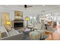 Open-concept living room featuring a modern fireplace, stylish furniture, and a seamless flow to the dining area at 501 Mallard Ave, Durham, NC 27701