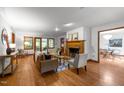 Inviting living room with hardwood floors, a cozy fireplace, and French doors leading to another room at 608 Valen Ct, Chapel Hill, NC 27516