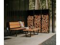 Inviting outdoor space with wood storage, bench, and coffee table, perfect for relaxation at 665 Lonach Ln, Roxboro, NC 27574