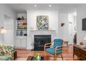 Cozy living room with a fireplace, built-in shelves, hardwood floors and stylish accents at 708 Copperline Dr # 101, Chapel Hill, NC 27516