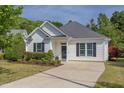 Charming single-story home with a well-maintained lawn, manicured shrubs, and a private driveway at 715 Barlang Cir, Fuquay Varina, NC 27526