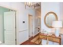 Hallway displaying wood floors, a console table with decor, and views into adjacent rooms at 715 Barlang Cir, Fuquay Varina, NC 27526