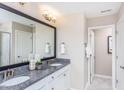 Elegant bathroom featuring double sinks, granite countertops, and modern fixtures at 718 Colby Pl, Durham, NC 27713