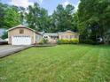 Charming ranch-style home with manicured lawn, mature trees, and a two-car garage in a neighborhood at 725 Van Thomas Dr, Raleigh, NC 27615