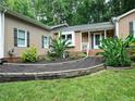 Inviting front entrance with manicured landscaping leading to the front porch of a ranch-style home at 725 Van Thomas Dr, Raleigh, NC 27615